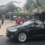 transportation service near me, image of tesla x picking up customers that need a ride.
