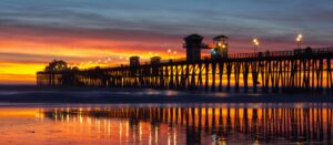 Panoramic view of Oceanside, CA pier during an unbelievable sunset with City Captain Transportation Service in Oceanside